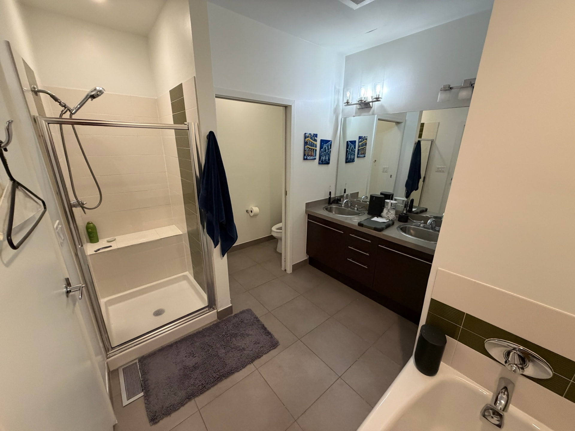 Original bathroom with framed shower enclosure and dark vanity